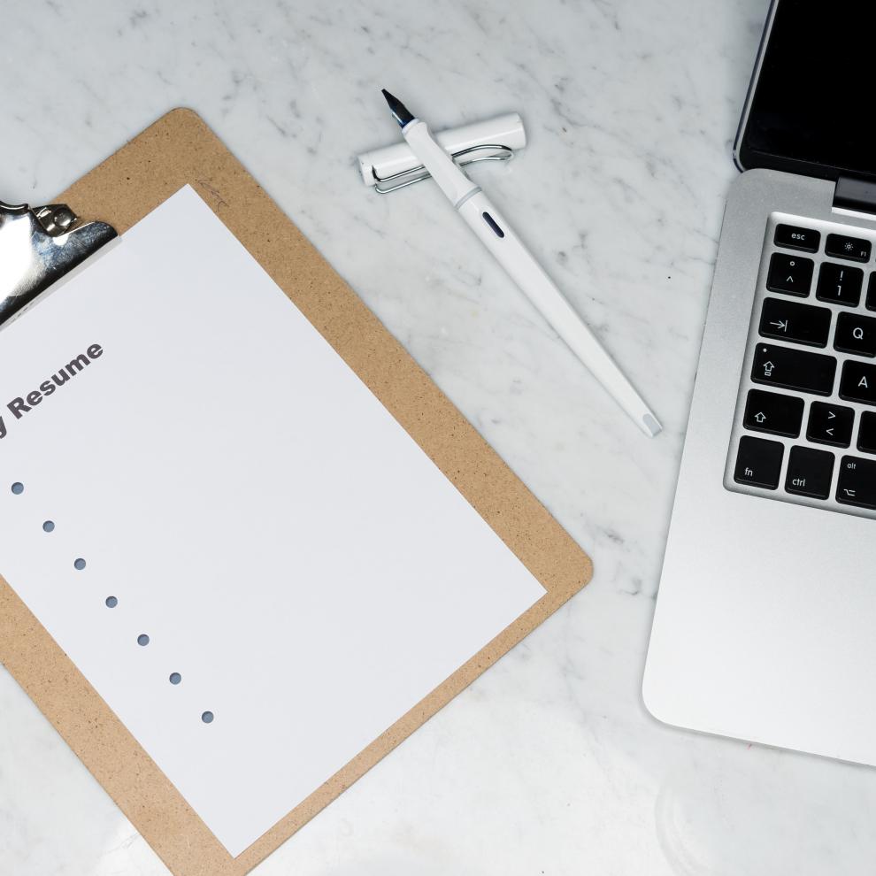 resume and the laptop on the desk